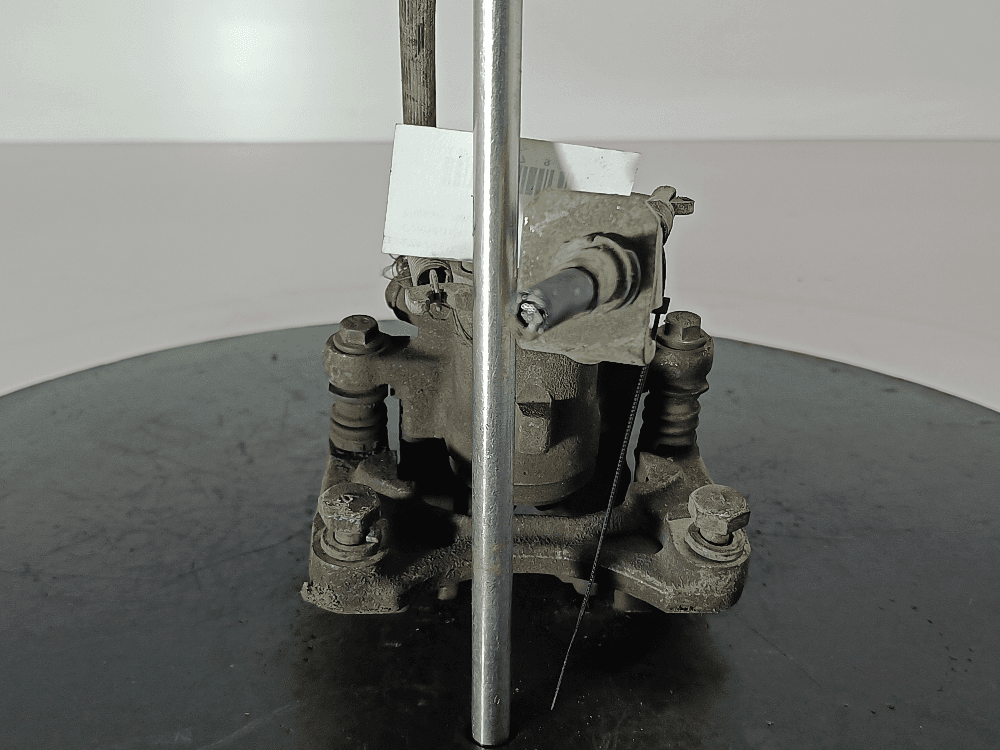 Суппорт задний левый к Nissan  Almera N16 (00-03)